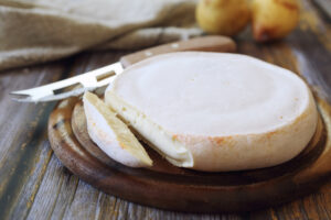 French Reblochon cheese on cutting board